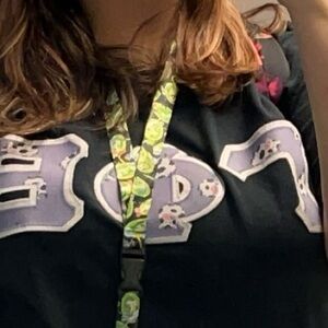 Black GPHI letter shirt with purple cow letters